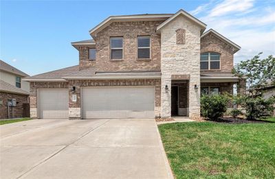 Attractive curb appeal is enhanced with brick and stone. There is even a front porch where you can sit and relax at the end of your work day! | Image 1