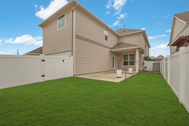 Back of house with a gate, a fenced backyard, a patio area, and roof with shingles | Image 34