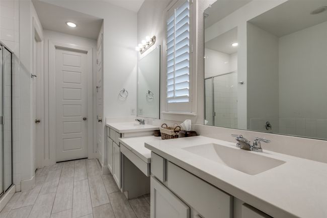 Bathroom featuring a sink, double vanity, and a stall shower | Image 24