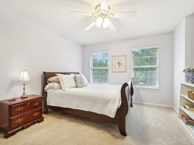 Bedroom featuring light carpet, baseboards, and a ceiling fan | Image 25