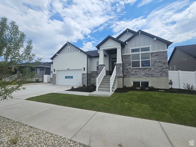 Craftsman house with board and batten siding, stone siding, concrete driveway, and a garage | Image 4