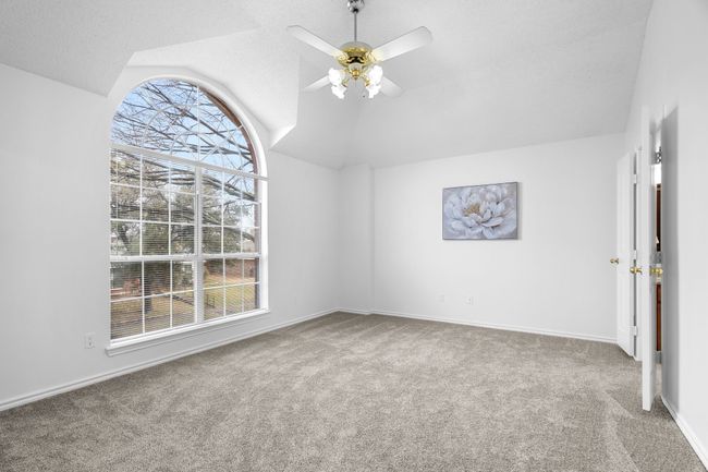 The primary bedroom has a beautiful window and two closets. | Image 25