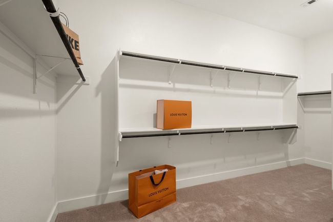Walk in closet with carpet floors | Image 18