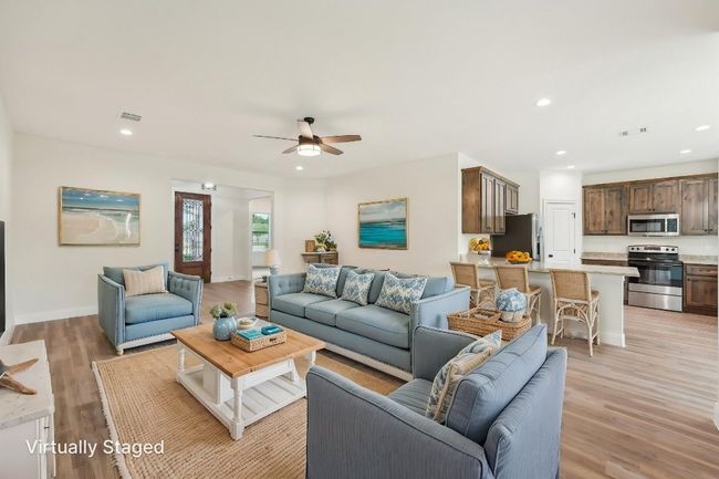 Virtually Staged Living room with Vinyl Wood Plank floor, visible vents, and ceiling fan | Image 12