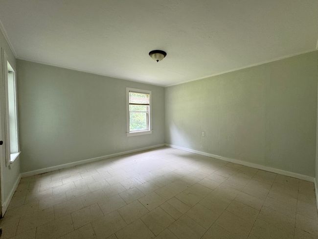 Unfurnished room with crown molding and tile patterned floors | Image 7