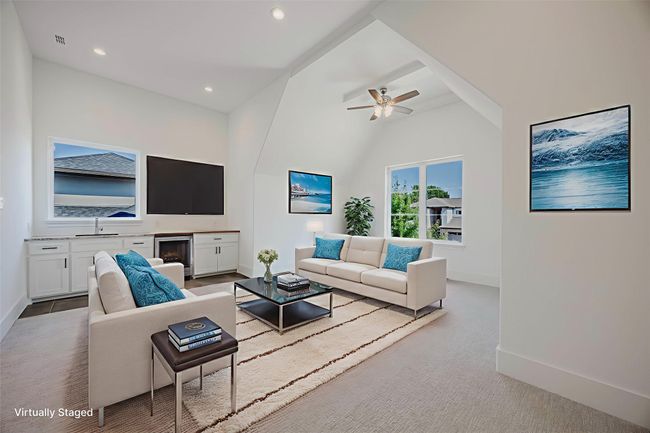 Living room with light colored carpet, wine cooler, ceiling fan, and recessed lighting | Image 24