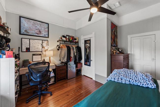 Bedroom featuring hardwood / wood-style floors, a closet, a desk, and a ceiling fan | Image 23