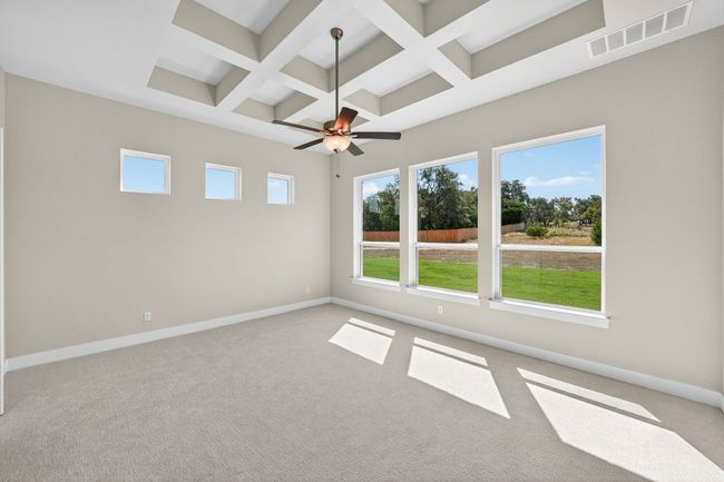 Unfurnished room featuring coffered ceiling, beamed ceiling, a ceiling fan, and light carpet | Image 11