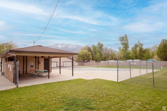 Surrounding community featuring a patio, a mountain view, fence, and a lawn | Image 22