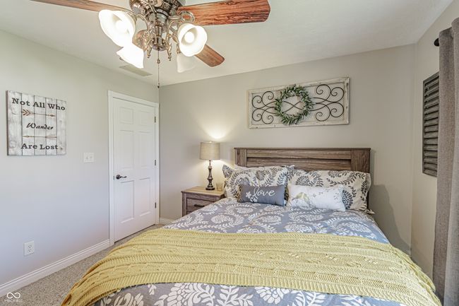 bedroom featuring ceiling fan, carpet floors, visible vents, and baseboards | Image 21