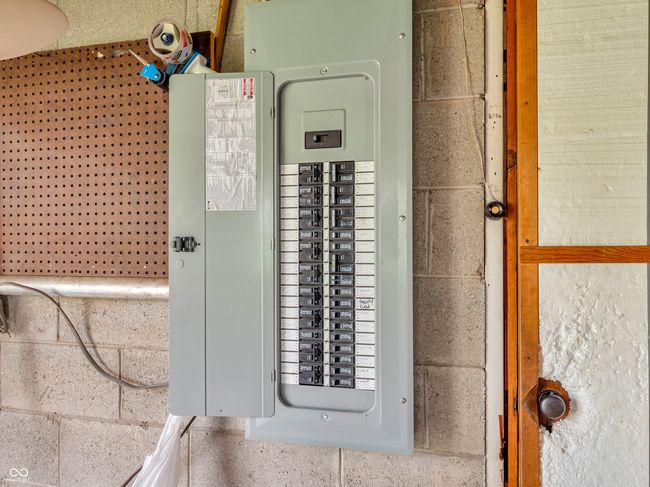 utility room featuring electric panel | Image 21