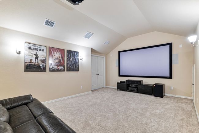 Cinema room featuring lofted ceiling, carpet, and baseboards | Image 24