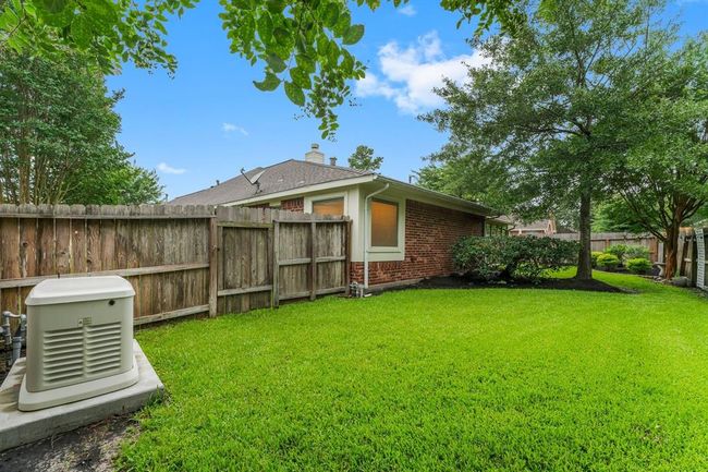 This home includes a Generac generator, offering peace of mind during unexpected outages. Enjoy year-round comfort in the fully enclosed sunroom, which is both air conditioned and heated. | Image 38