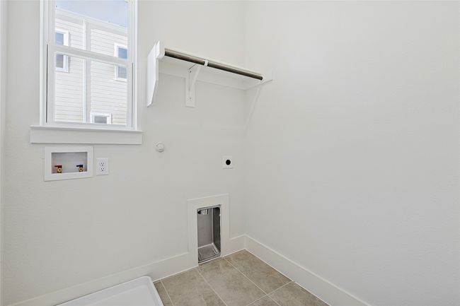Laundry area with washer hookup, gas dryer hookup, hookup for an electric dryer, and light tile patterned floors | Image 40