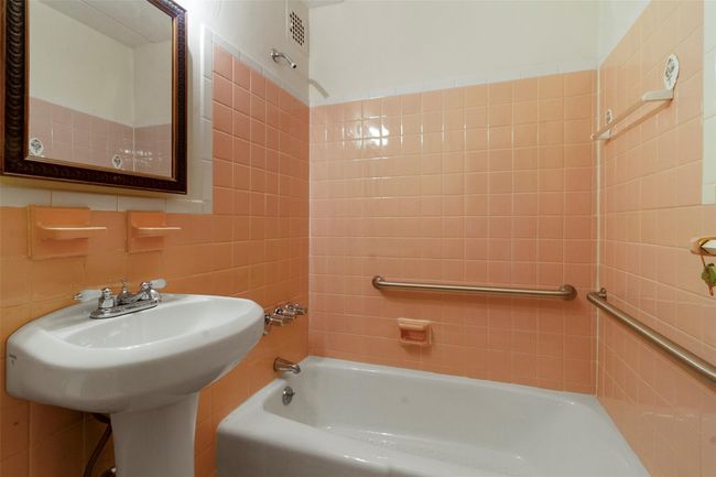 Full bathroom with shower combination and tile walls | Image 23