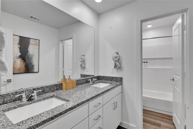 Full bath with double vanity, visible vents, a sink, and wood finished floors | Image 24