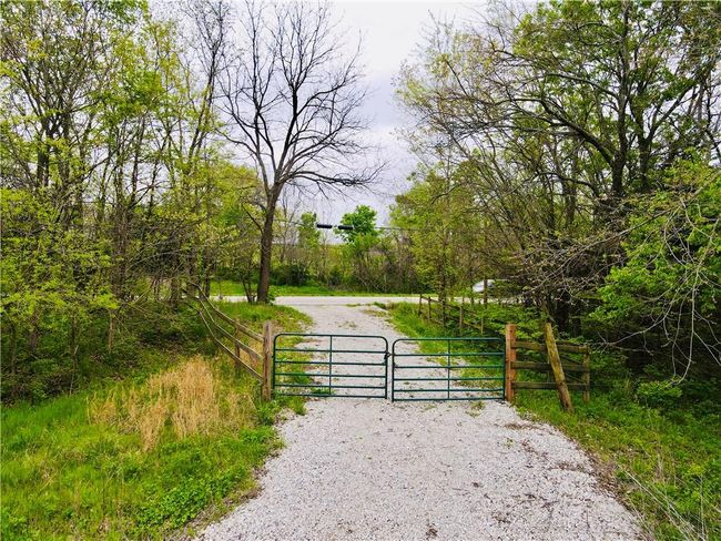 View of street with a gate and a gated entry | Image 9