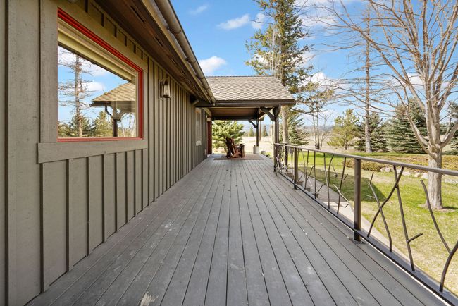 View of deck with Primary Bedroom Sitting area in the distance | Image 36