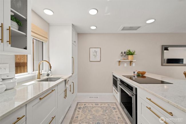 Sleek, designer styled kitchen with induction cooktop. | Image 10