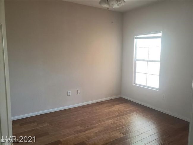 Spare room with dark wood-type flooring and ceiling fan | Image 14
