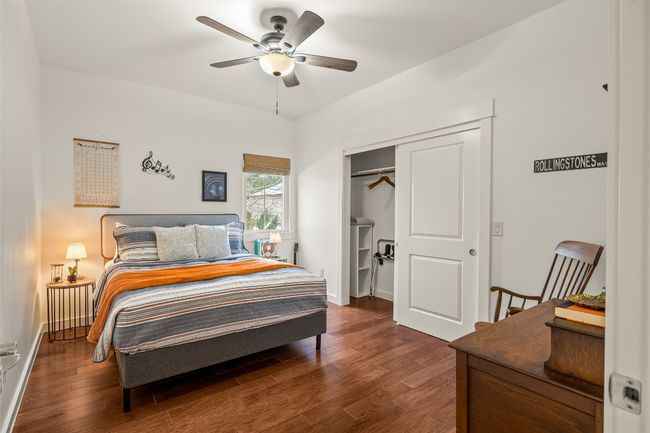 Bedroom with dark wood-style flooring, a closet, and a ceiling fan | Image 23