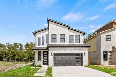 Contemporary house featuring a garage and a lawn | Image 2