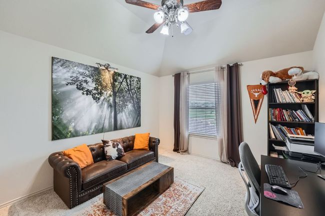 Home office with vaulted ceiling, a ceiling fan, and light carpet | Image 25
