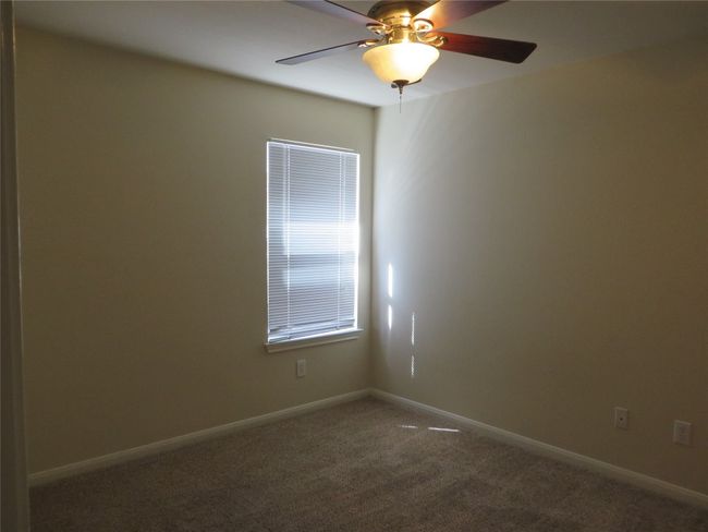 Unfurnished room featuring carpet, a ceiling fan, and baseboards | Image 4