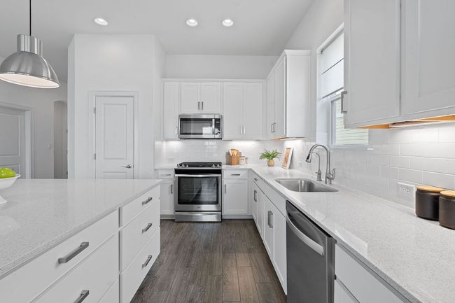 Timeless shaker-style cabinetry provides an abundance of storage space including pull out drawers and tall, under-lit upper cabinets. | Image 16