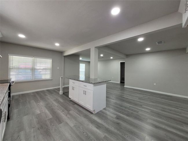 Kitchen, Dining and Living room spaces. | Image 12