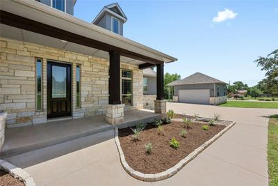 Shady and welcoming front porch has plenty of room for furniture. Beautiful stone facade for beauty and insulation. Front door was recently restained. | Image 3