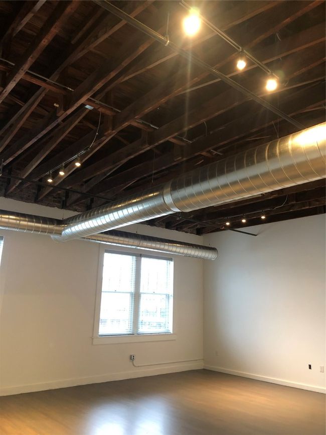 Basement featuring rail lighting and baseboards | Image 11