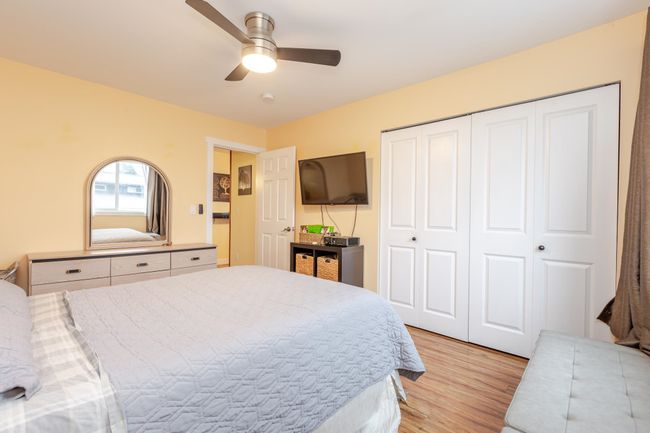 Bedroom featuring light wood-style floors, a closet, and a ceiling fan | Image 12