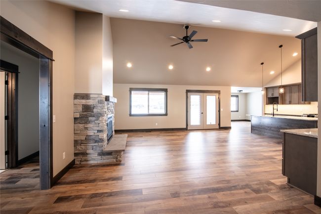 Unfurnished living room with high vaulted ceiling, sink, dark hardwood / wood-style flooring, ceiling fan, and french doors | Image 28