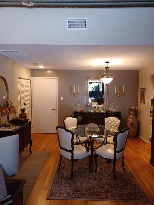Standing in the living room with the doors to the deck behind you, looking toward the entry door. | Image 9