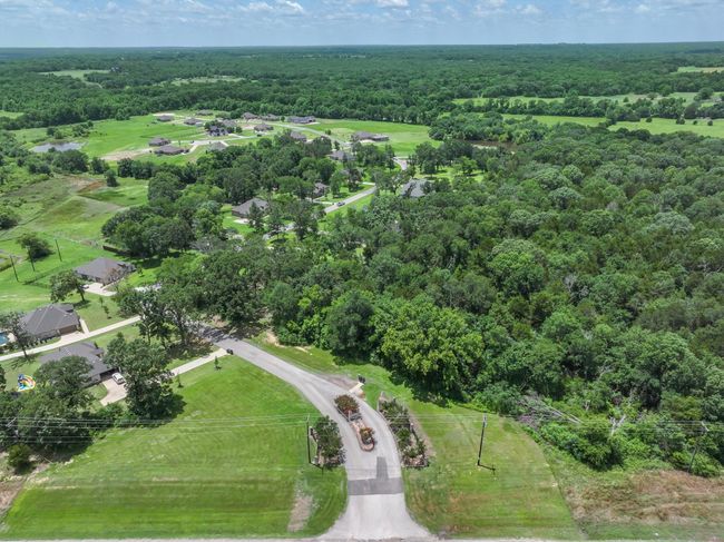 Entrance to neighborhood with winding roads and trees | Image 4