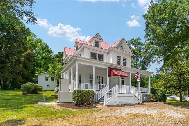 Victorian house with covered porch, a front yard, and stairway | Image 4