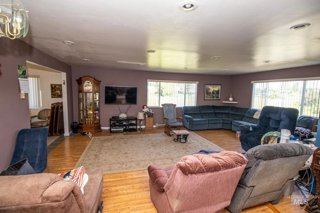 Living room with healthy amount of natural light, wood finished floors, and recessed lighting | Image 12