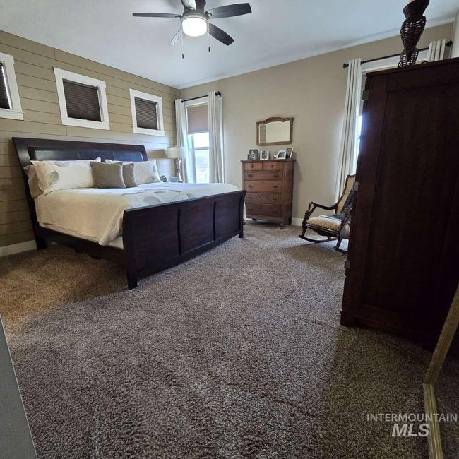 Carpeted bedroom featuring ceiling fan and baseboards | Image 15
