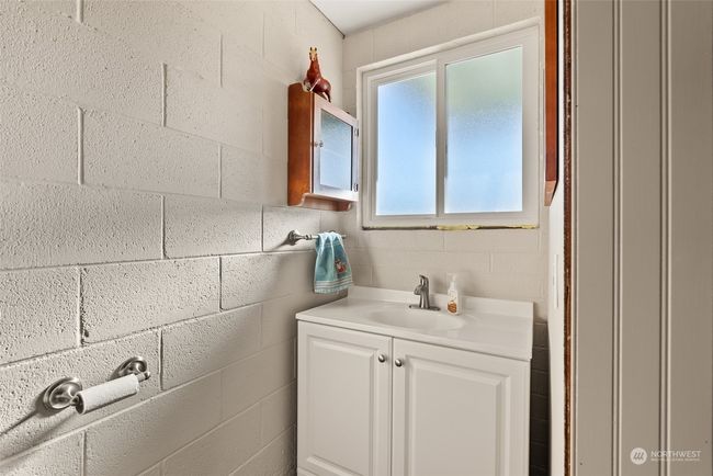The lower-level half bath comes equipped with plumbing already in place for a shower, offering the perfect opportunity to customize and finish the space to your liking. It gives you the opportunity to enhance the functionality of the lower level | Image 25
