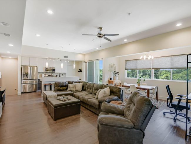 Living room featuring a ceiling fan, light wood-type flooring, recessed lighting, and a chandelier | Image 8