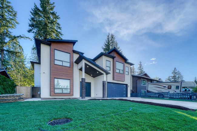Modern home with stucco siding, a garage, and driveway | Image 31
