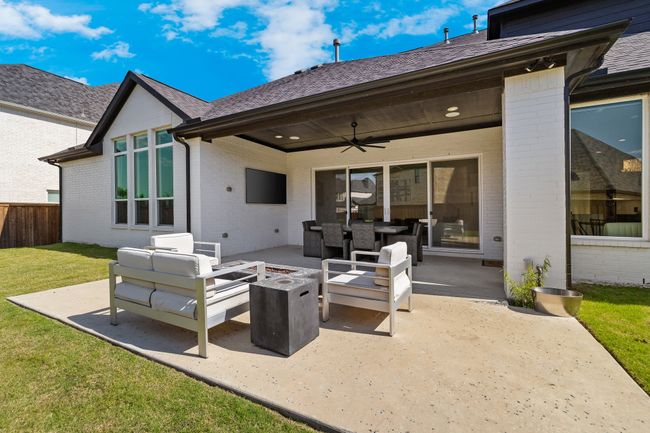 View of patio featuring an outdoor living space with a fire pit and a ceiling fan | Image 39
