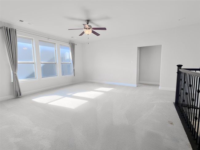 Carpeted empty room with ceiling fan and baseboards | Image 36