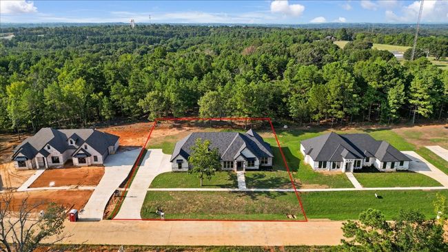 Aerial view of property and surrounding area featuring property boundaries highlighted and a forest | Image 5