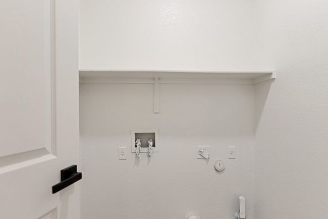 Washroom with gas dryer hookup, washer hookup, and hookup for an electric dryer | Image 5