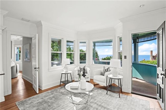 PRIMARY SUITE // Sitting room with private balcony. Enjoy the breeze off the water with incredible views. | Image 15
