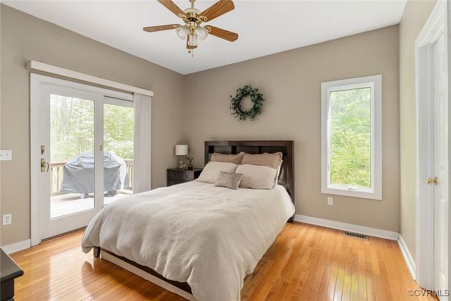 First floor bedroom with doors to the deck | Image 20