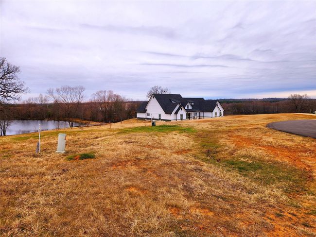 This what the left side view of the neighboring lot and pond view look like. | Image 13