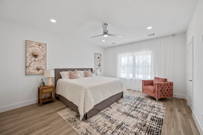 Bedroom with light wood-style floors, a ceiling fan, and recessed lighting | Image 11